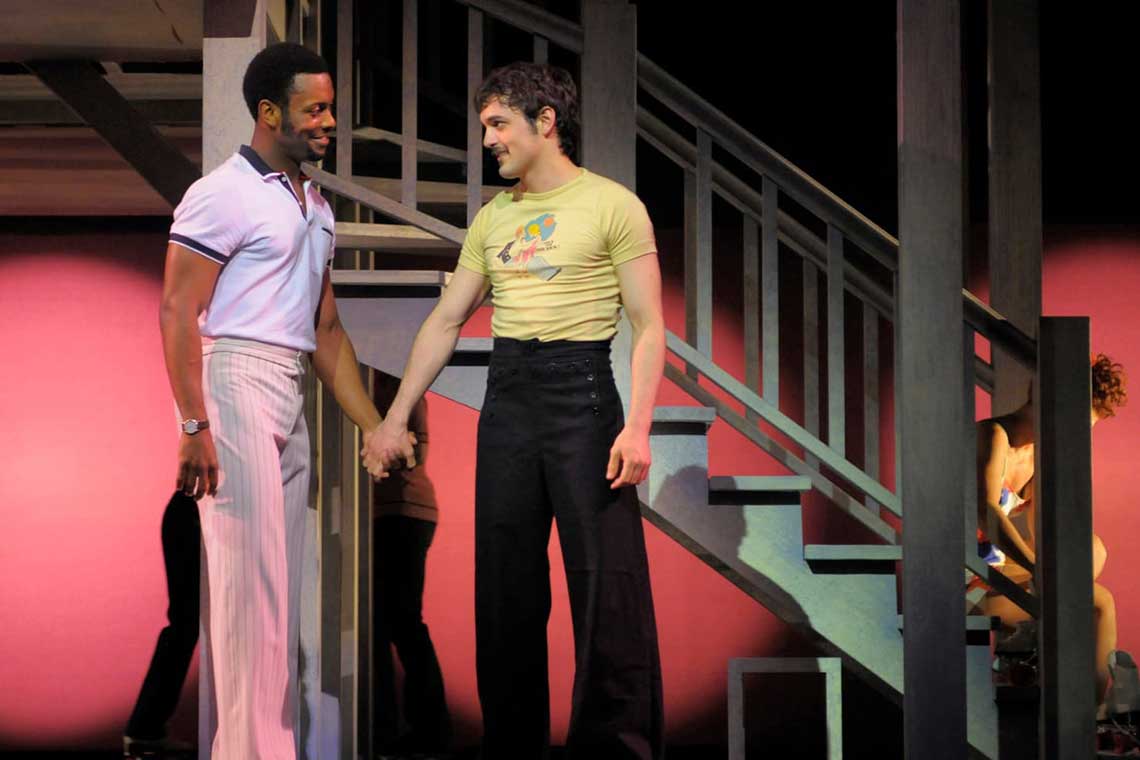 Michael “Mouse” Tolliver (Wesley Taylor, right) runs into the handsome Jon Fielding (Josh Breckenridge) at the roller rink in "Armistead Maupin’s Tales of the City, The Musical".