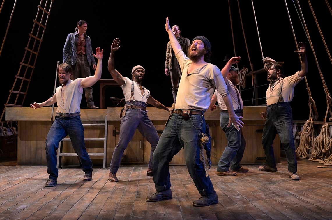 six men stand on the deck of a ship in various positions of dance. stage image of Swept Away