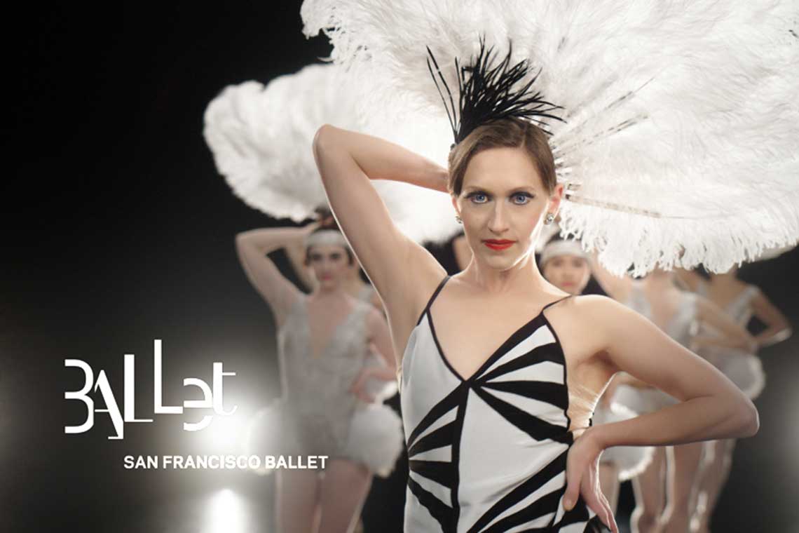 ballet dancer Sarah Van Patten stands in foreground with a large white feather fan behind her head