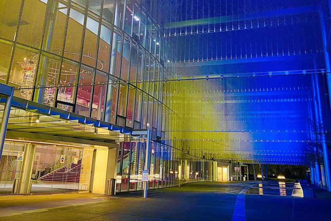 mccaw hall lit up in yellow and blue lights for the unity concert
