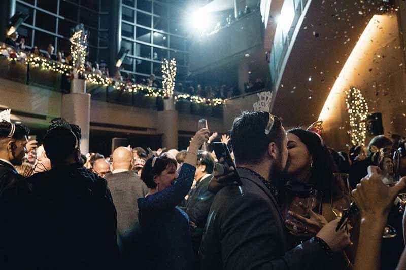 a crowd of people celebrate new year's eve in benaroya hall