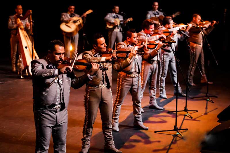 a mariachi band plays on stage