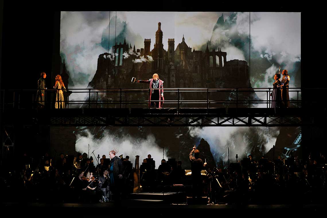 a dark image that shows a stage with fog and a castle in the background