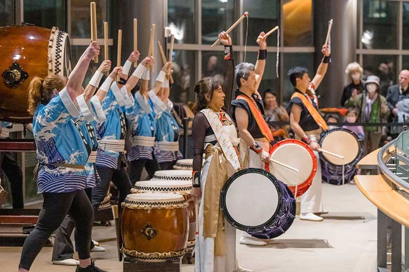 A long row of Chinese drummers in action
