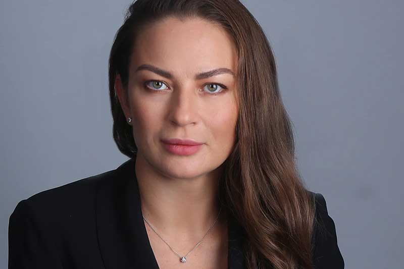 headshot of a white woman with brown hair