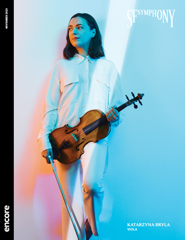 Katarzyna Bryla on a blue and pink background holding a violin | Cover of SF Symphony November 2023