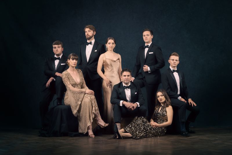 A group of people dressed in black tie.