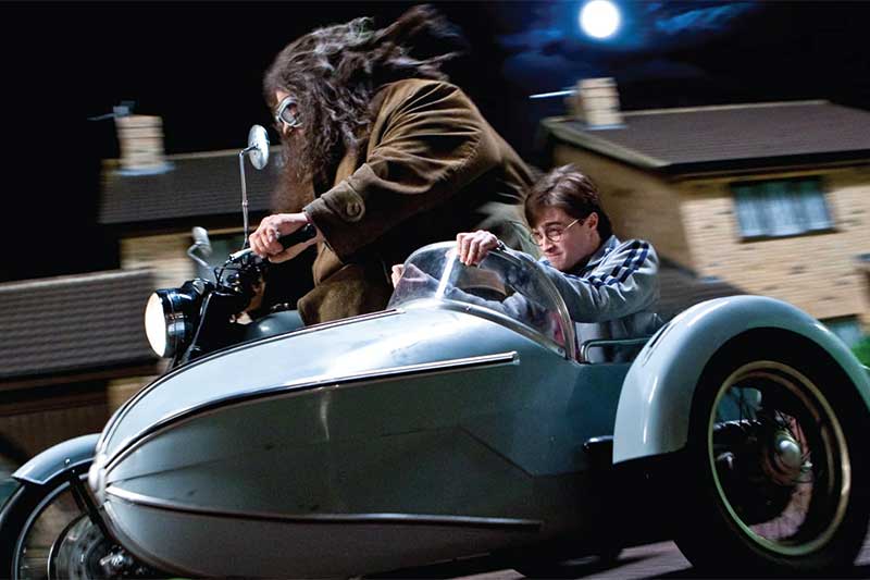 A still from Harry Potter showing Hagrid and Harry on a motorcycle
