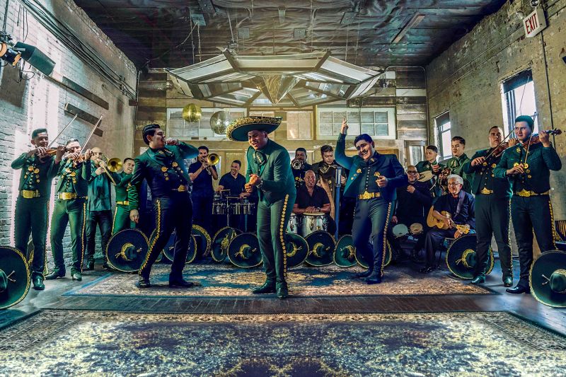 A mariachi band plays in blue clothes.